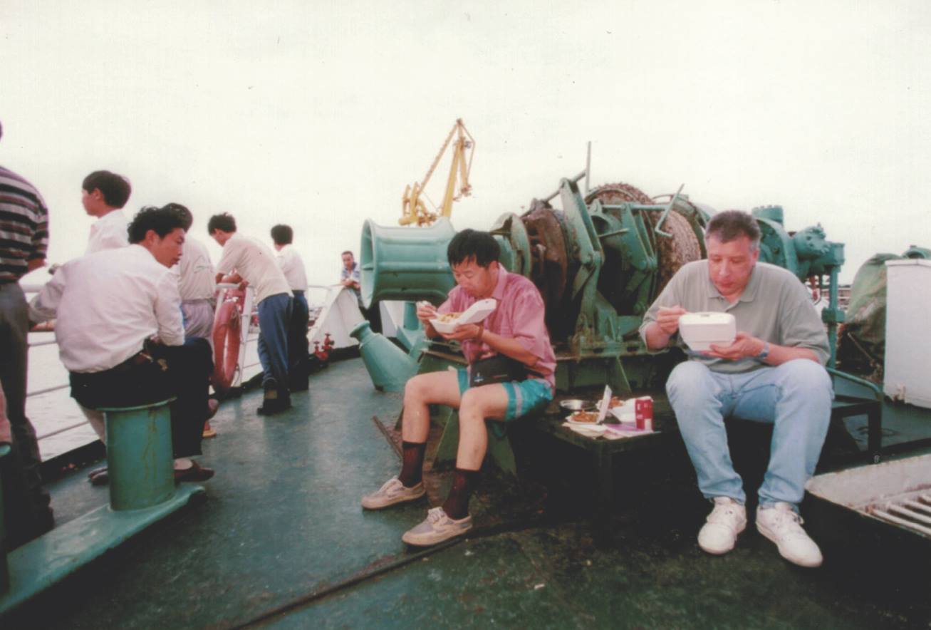 En route to Behai, China, Dahlby and his fixer Li Hubing eat chicken feet aboard a ferry. Photo courtesy of Michael Yamashita.