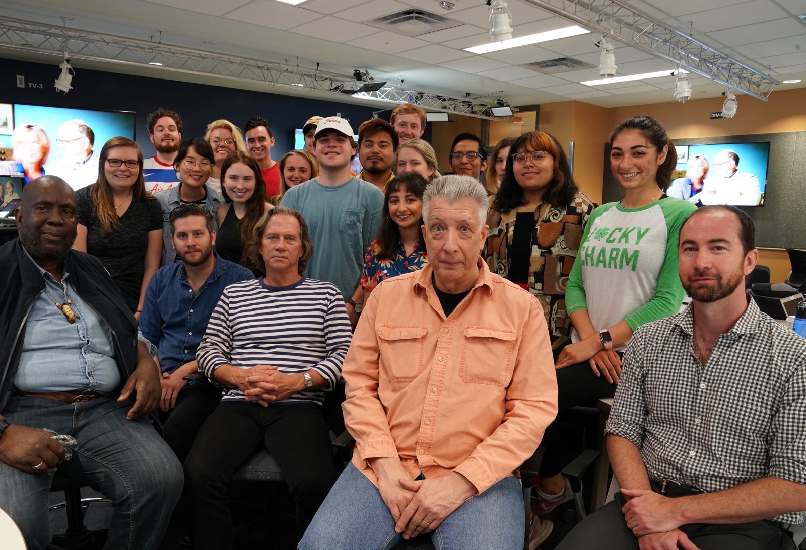 Joined by former journalism professor Eli Reed (far left) and journalism lecturer John Savage (far right), Dahlby poses for a photo with the Reporting Texas newsroom class.