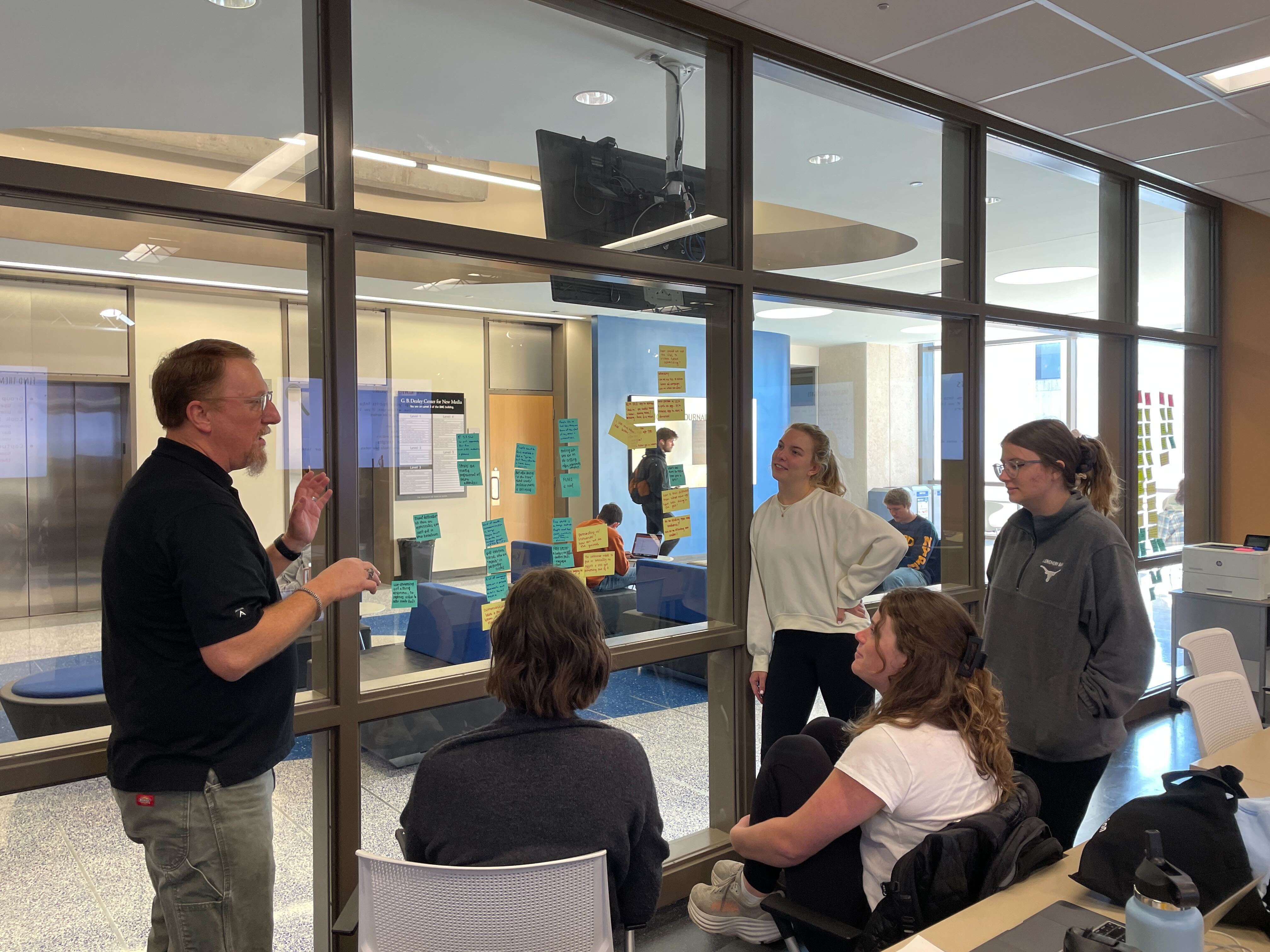 professor talking with students about project