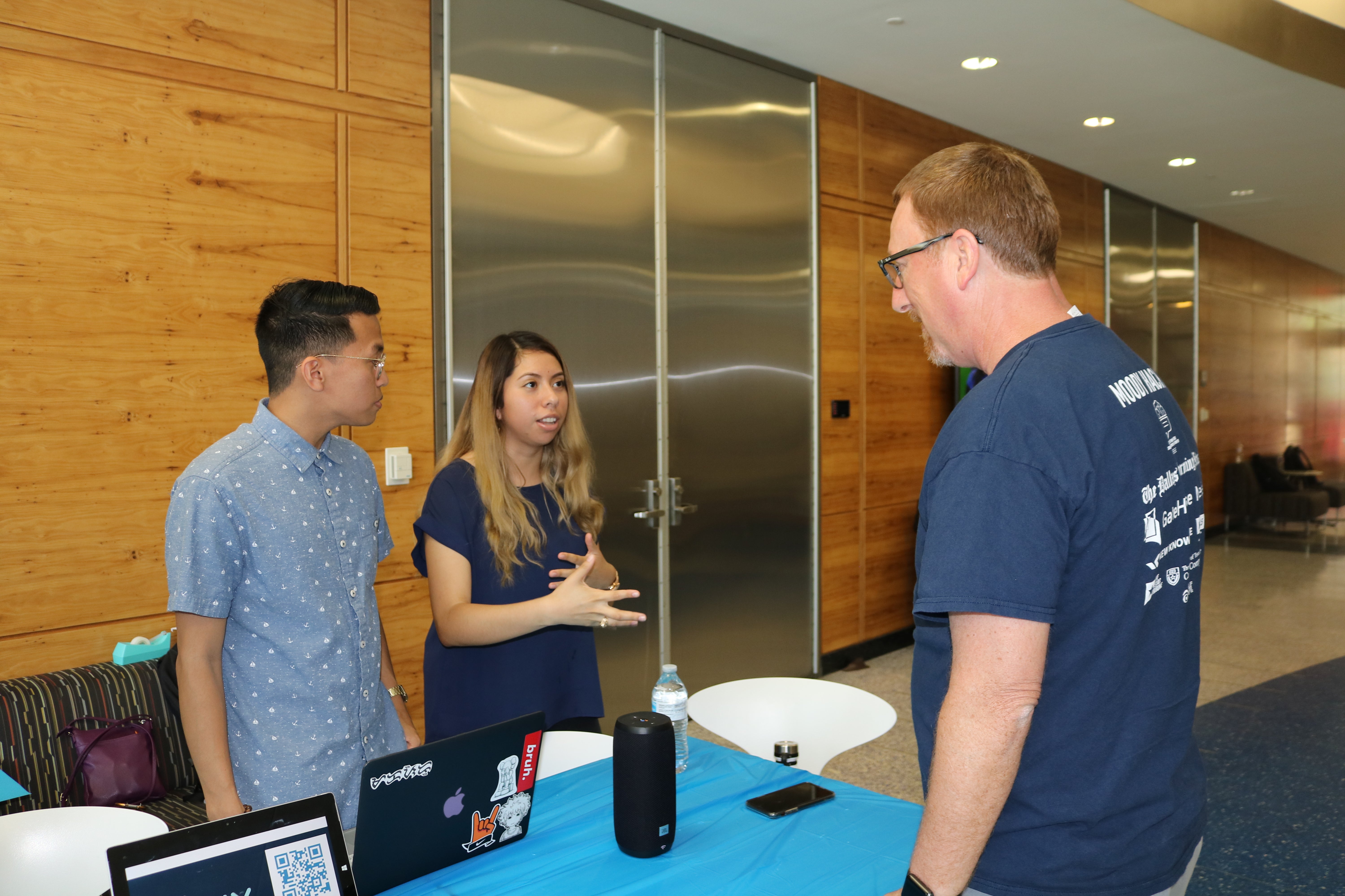 Student team presents an app they built at a table setup