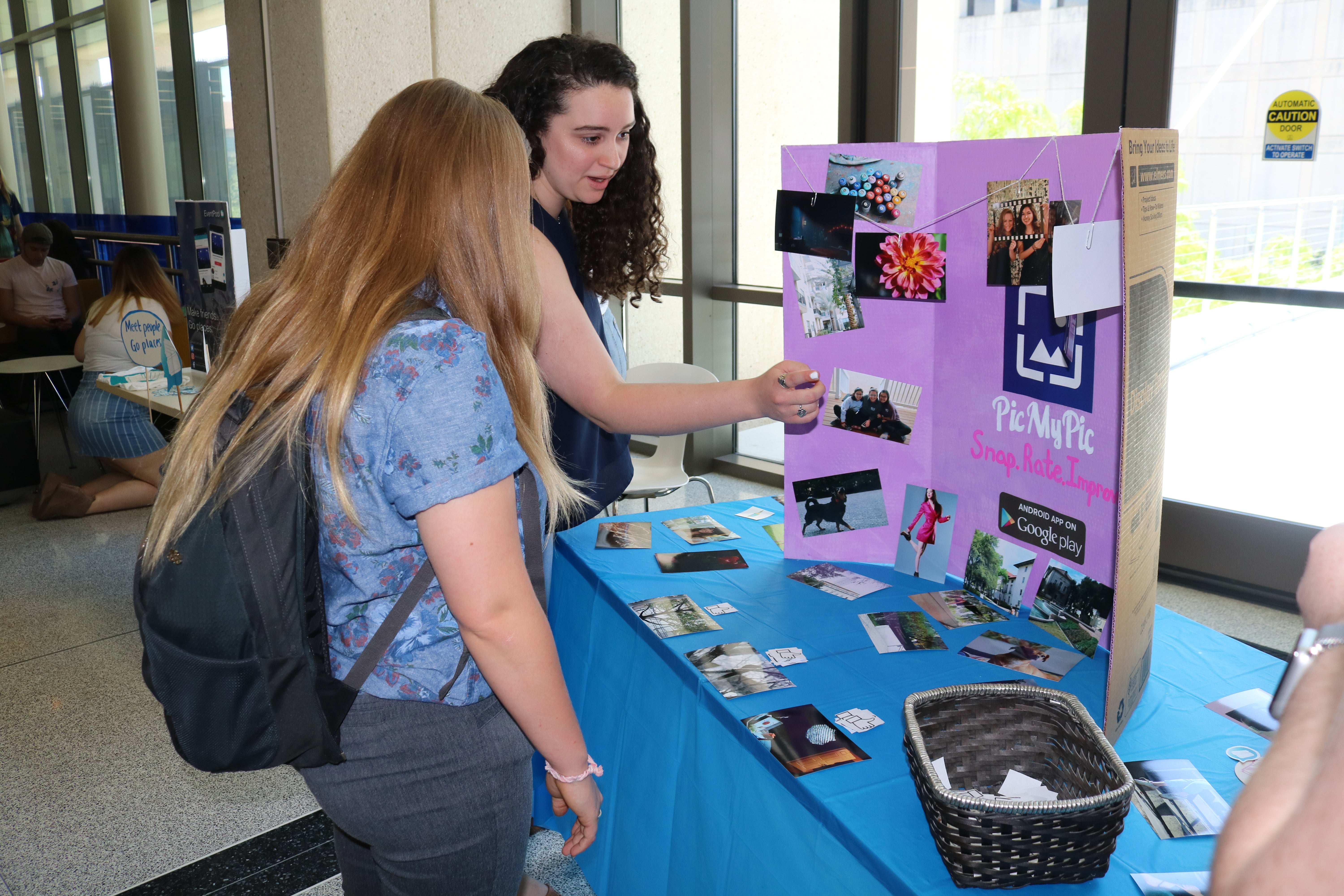 Student team presents an app they built at a table setup