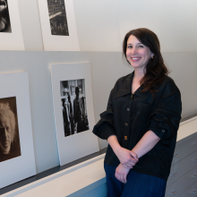 Christine Robinson next to an exhibit at the Harry Ransom Center