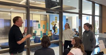 professor talking with students about project
