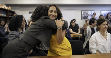 Cassandra Jaramillo hugs someone during the 2025 Pulitzer Prize announcements.
