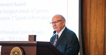 Griff Singer stands at a podium.