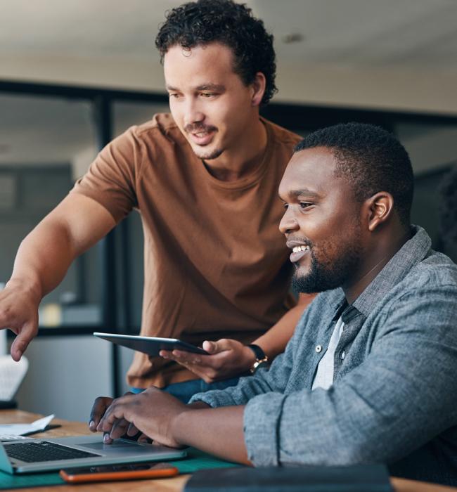 two professionals working together at a desk
