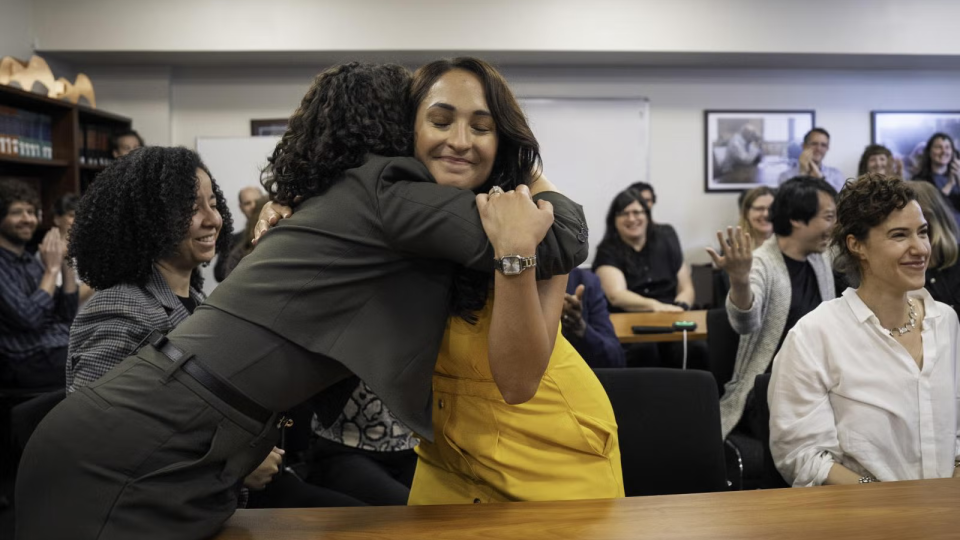 Cassandra Jaramillo hugs someone during the 2025 Pulitzer Prize announcements.
