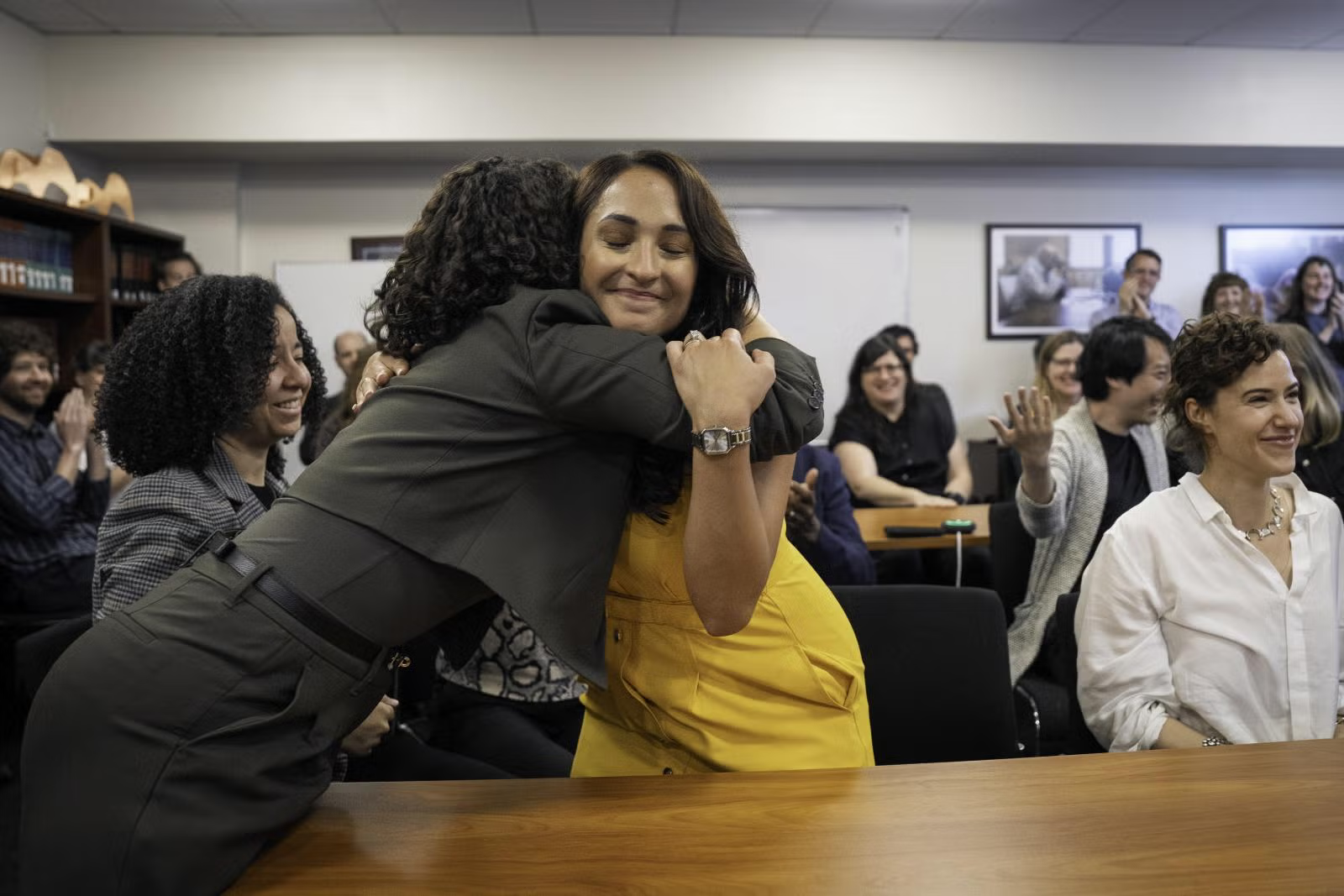 Cassandra Jaramillo hugs someone during the 2025 Pulitzer Prize announcements.