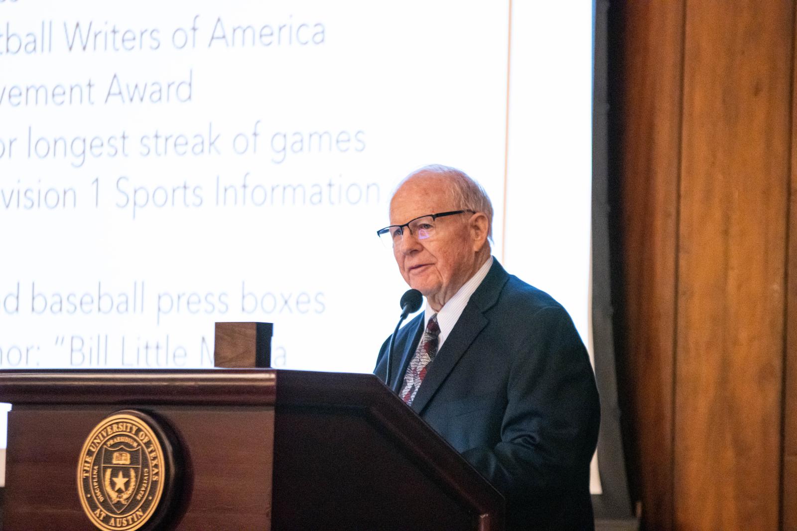 Griff Singer stands at a podium.