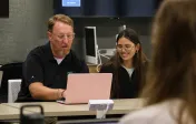 Professor and student looking at computer