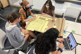 Students working around a table.