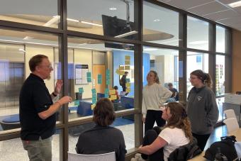 professor talking with students about project