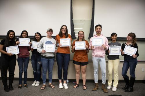 winning teams pose with their certificates