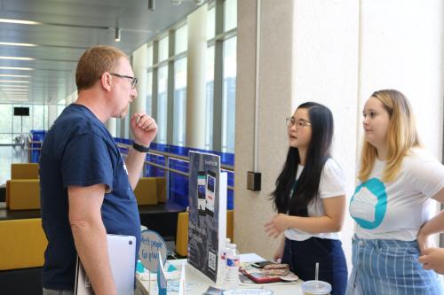 Professor Christian McDonald talks to a student team that built an app called EventPool