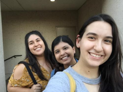 The hosts of the podcast Young and Confused pose for a picture in the Walter Cronkite plaza at UT.