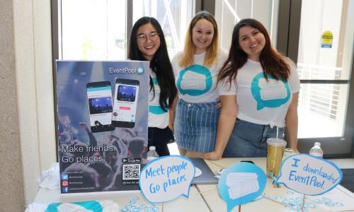 Student team for Event Pool poses by their presentation table