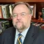 Headshot of Don Heider with library in background