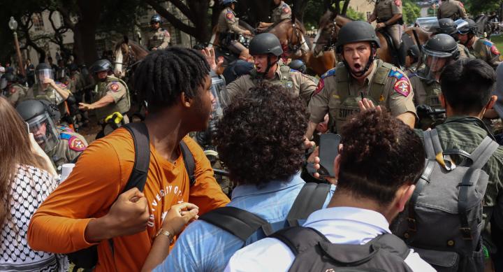 Students are pushed back by law enforcement officers